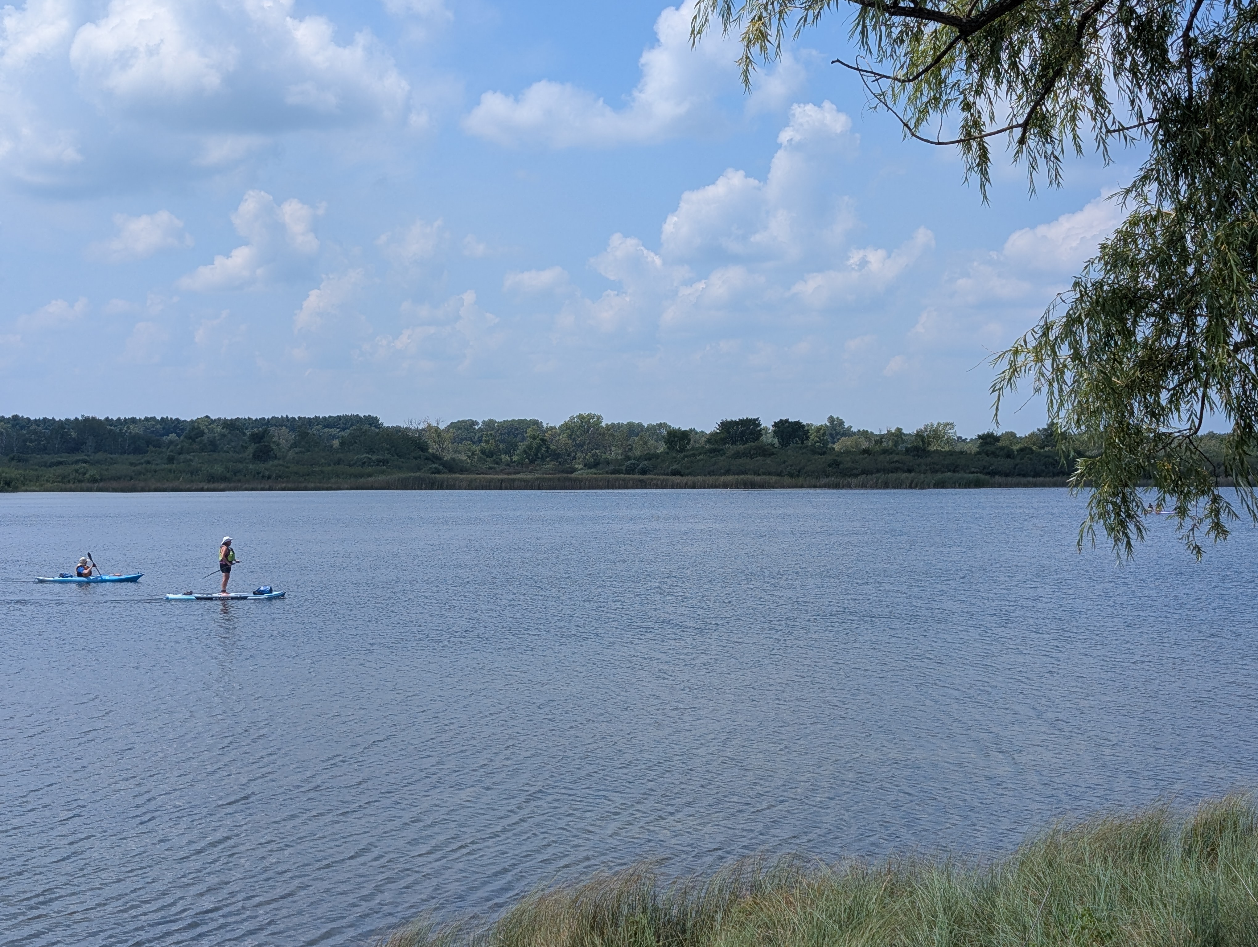 picture of a lake with two people on canoes